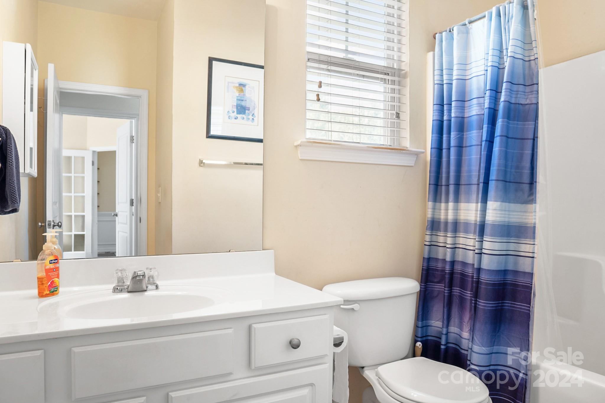 508 Marblewood Court Fort Mill, SC 29708 - Photo 19 of 21 a bathroom with a sink a toilet and shower curtain