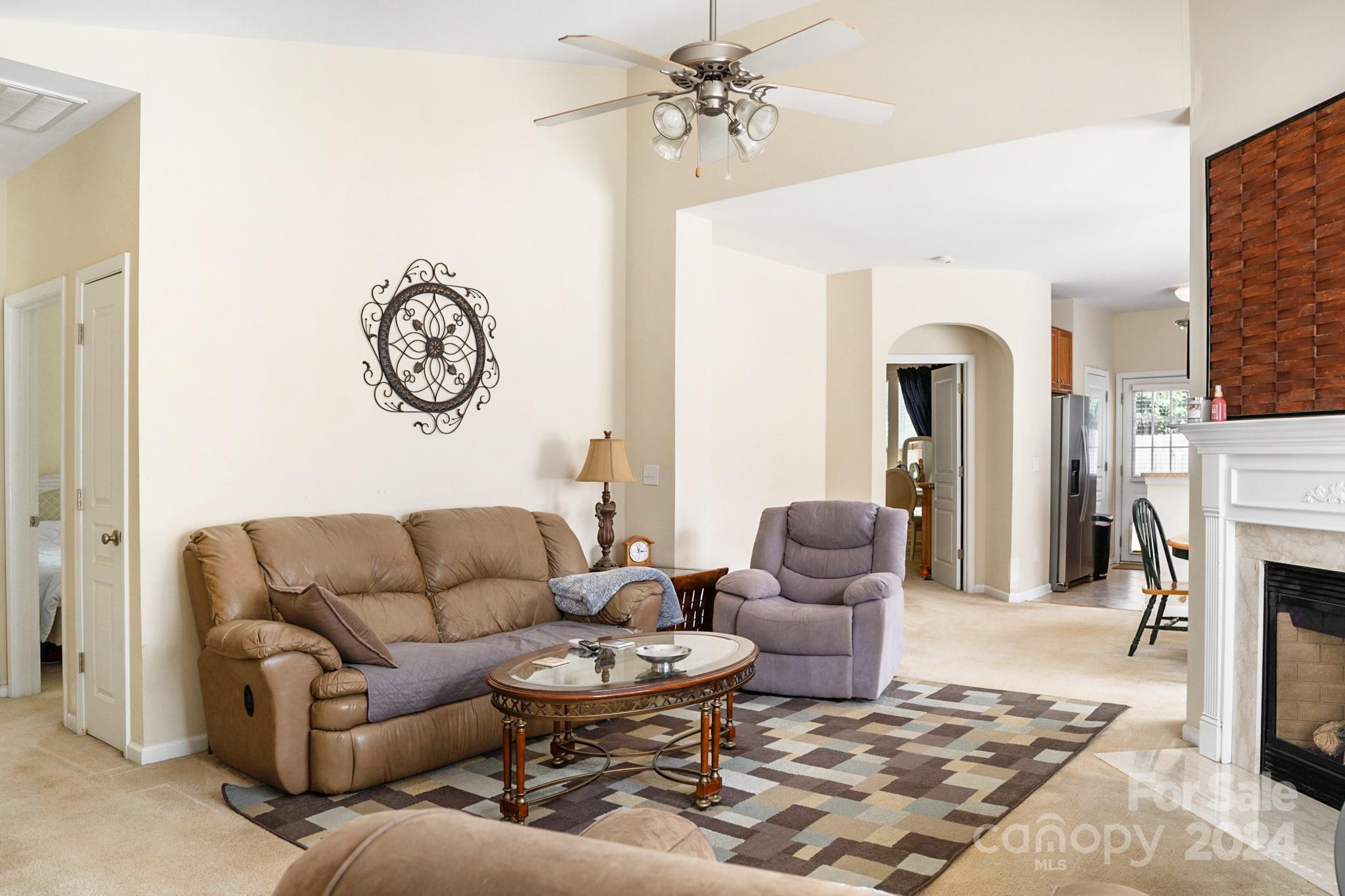 508 Marblewood Court Fort Mill, SC 29708 - Photo 5 of 21 a living room with furniture a fireplace and a chandelier
