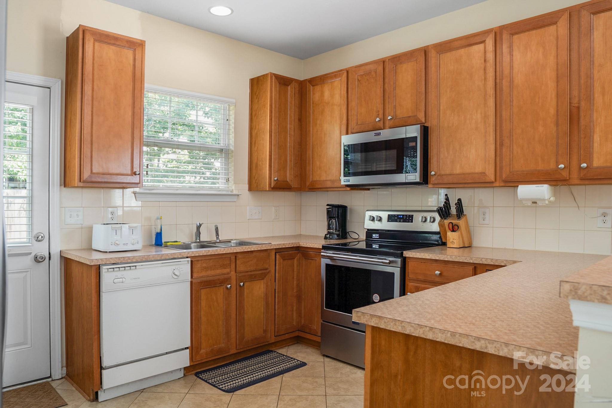 508 Marblewood Court Fort Mill, SC 29708 - Photo 8 of 21 a kitchen with stainless steel appliances granite countertop wooden cabinets a sink and a stove