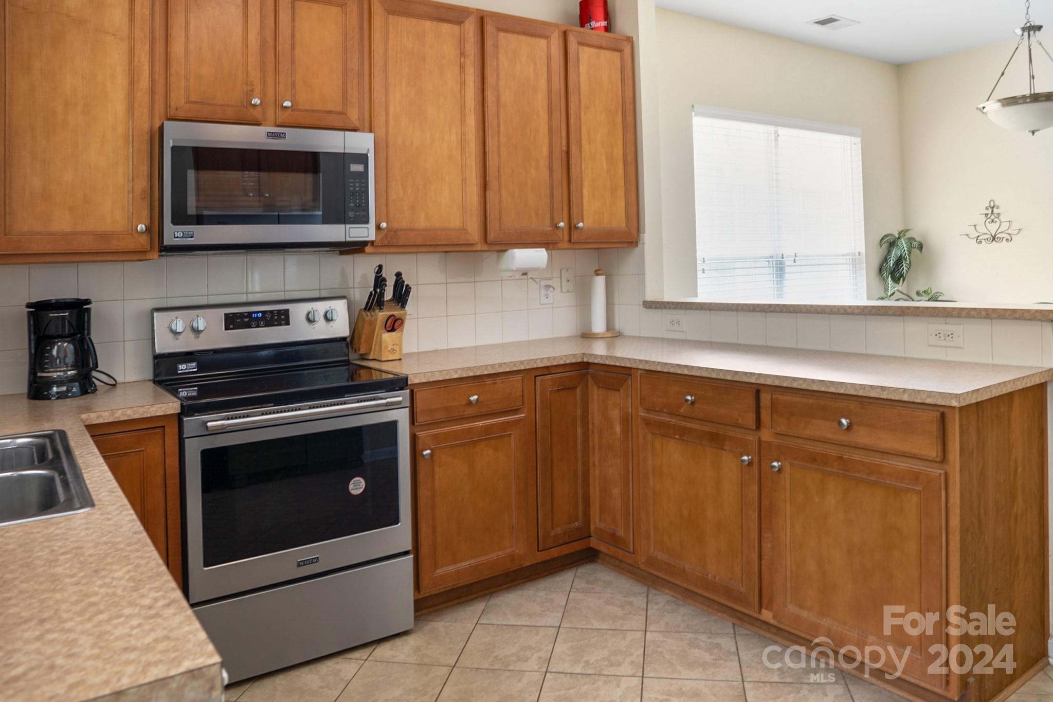 508 Marblewood Court Fort Mill, SC 29708 - Photo 9 of 21 a kitchen with granite countertop a stove top oven microwave and cabinets