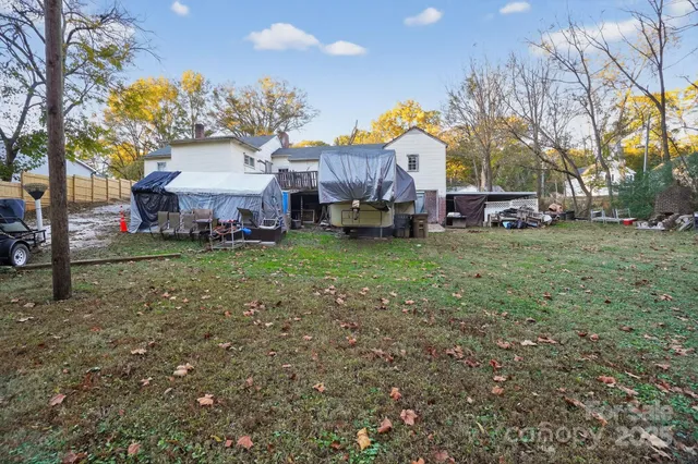 a view of a house with a yard and sitting area