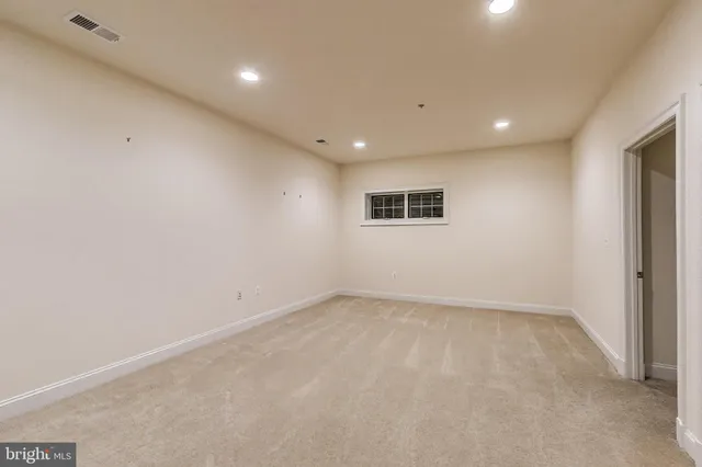 a view of an empty room and closet area