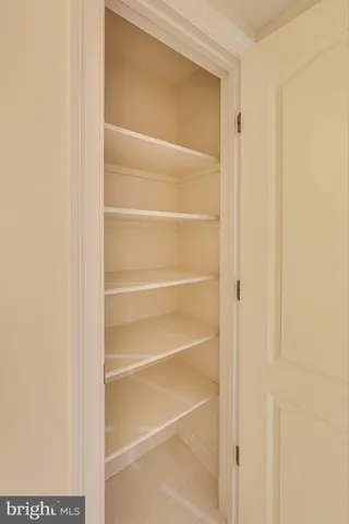 a backyard of a house with large tree and wooden fence