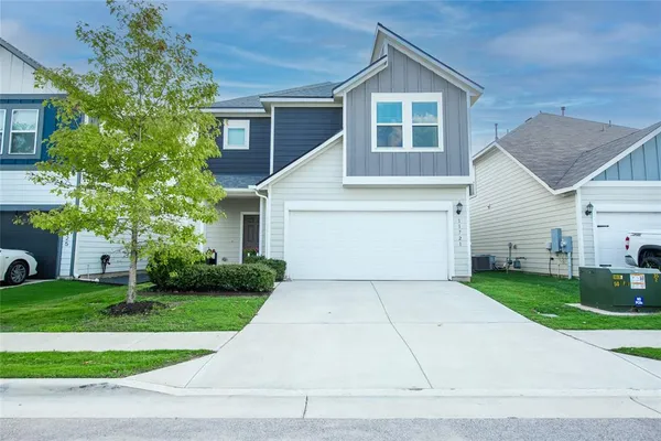 a front view of a house with a yard and garage