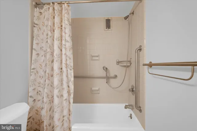 a bathroom with a shower curtain and a shower