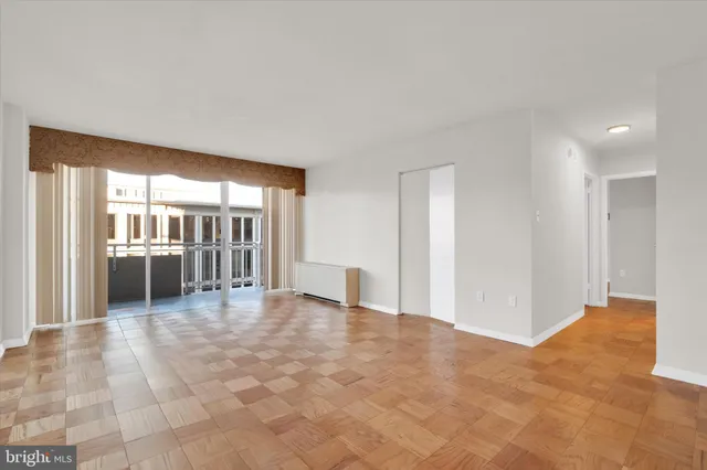 a view of a big room with windows and entryway