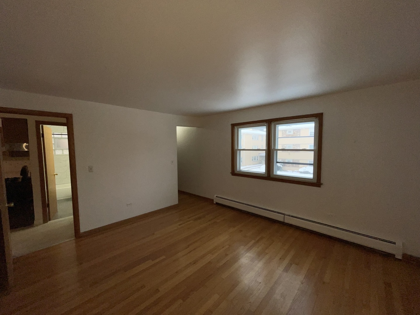 8511 West Gregory Street, Unit 2N Chicago, IL 60656 - Photo 11 of 15 an empty room with wooden floor and windows