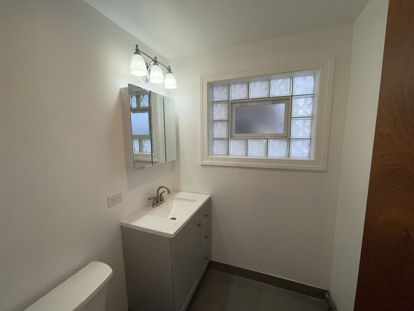 8511 West Gregory Street, Unit 2N Chicago, IL 60656 - Photo 13 of 15 a bathroom with a sink toilet and mirror