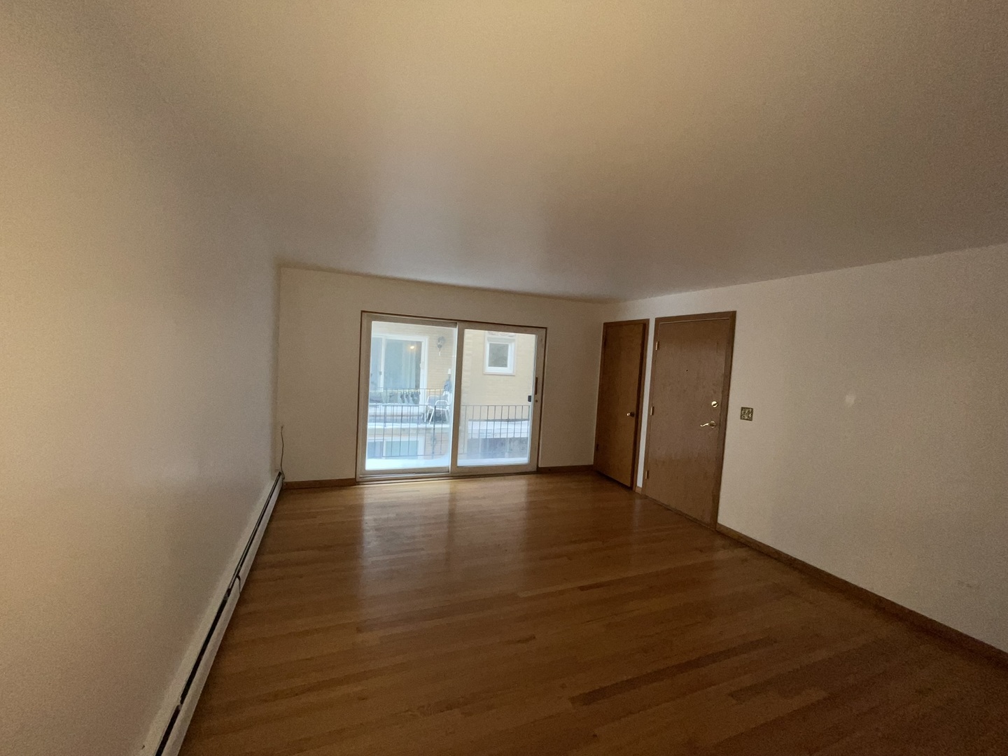 8511 West Gregory Street, Unit 2N Chicago, IL 60656 - Photo 14 of 15 an empty room with wooden floor and windows