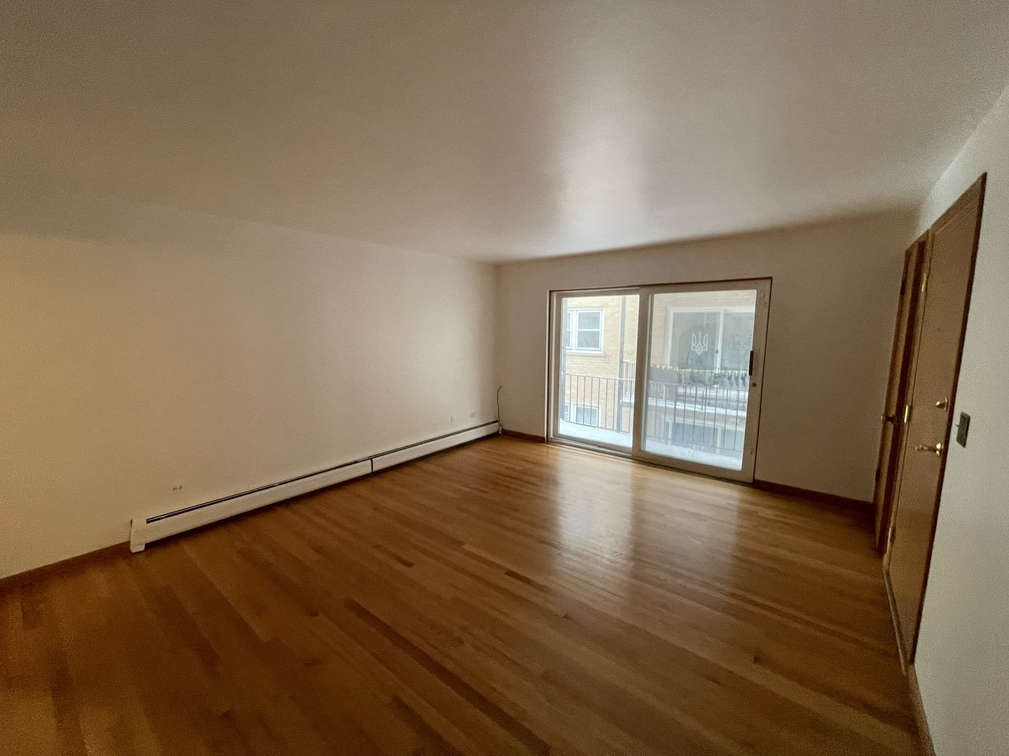8511 West Gregory Street, Unit 2N Chicago, IL 60656 - Photo 2 of 15 a view of an empty room with wooden floor and a window