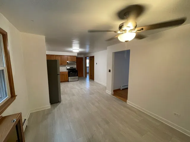 a view of empty room with wooden floor