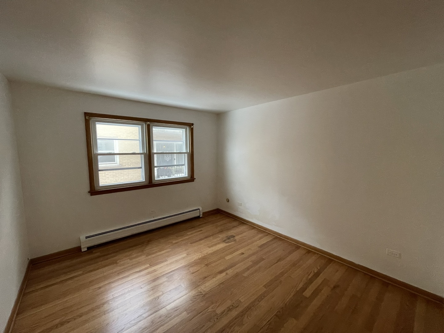 8511 West Gregory Street, Unit 2N Chicago, IL 60656 - Photo 9 of 15 an empty room with wooden floor and windows