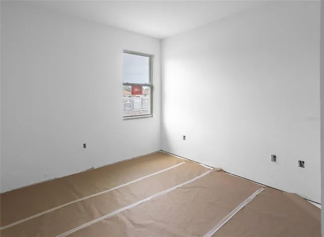 a kitchen with kitchen island a dining table chairs stainless steel appliances and cabinets