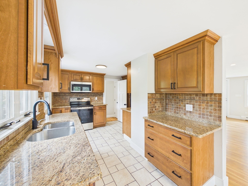 9 Burt Street Acushnet, MA 02743 - Photo 11 of 29 a kitchen with granite countertop a sink and a stove