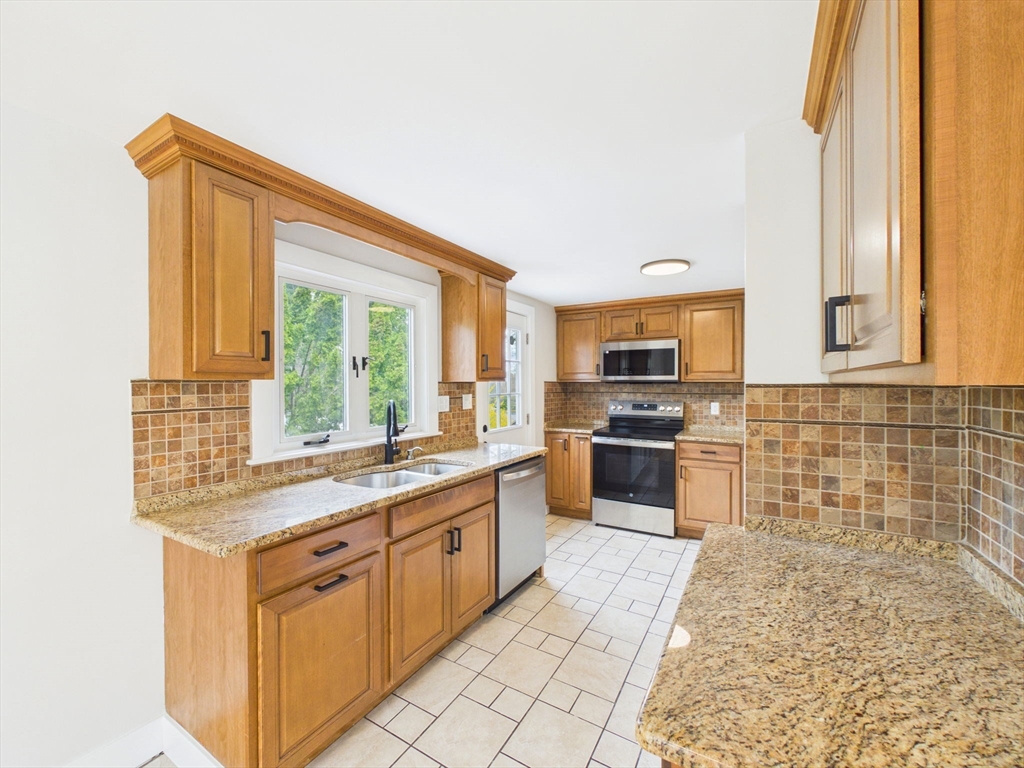 9 Burt Street Acushnet, MA 02743 - Photo 12 of 29 a kitchen with stainless steel appliances granite countertop a stove a sink and a microwave