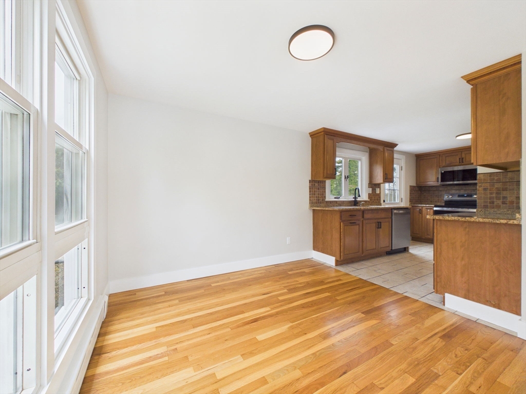 9 Burt Street Acushnet, MA 02743 - Photo 14 of 29 a view of a kitchen with wooden floor electronic appliances and windows