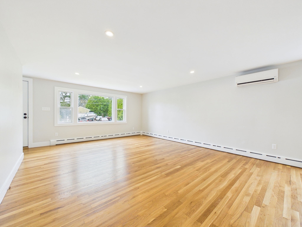 9 Burt Street Acushnet, MA 02743 - Photo 16 of 29 an empty room with wooden floor and windows