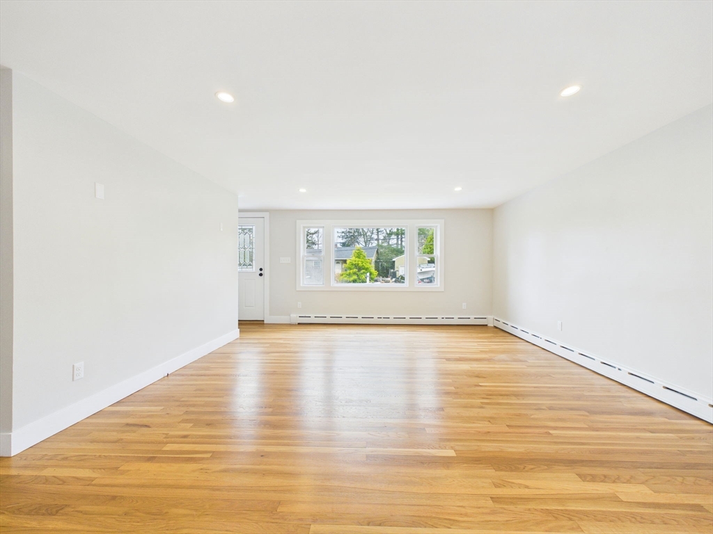 9 Burt Street Acushnet, MA 02743 - Photo 17 of 29 a view of an empty room with wooden floor and a window