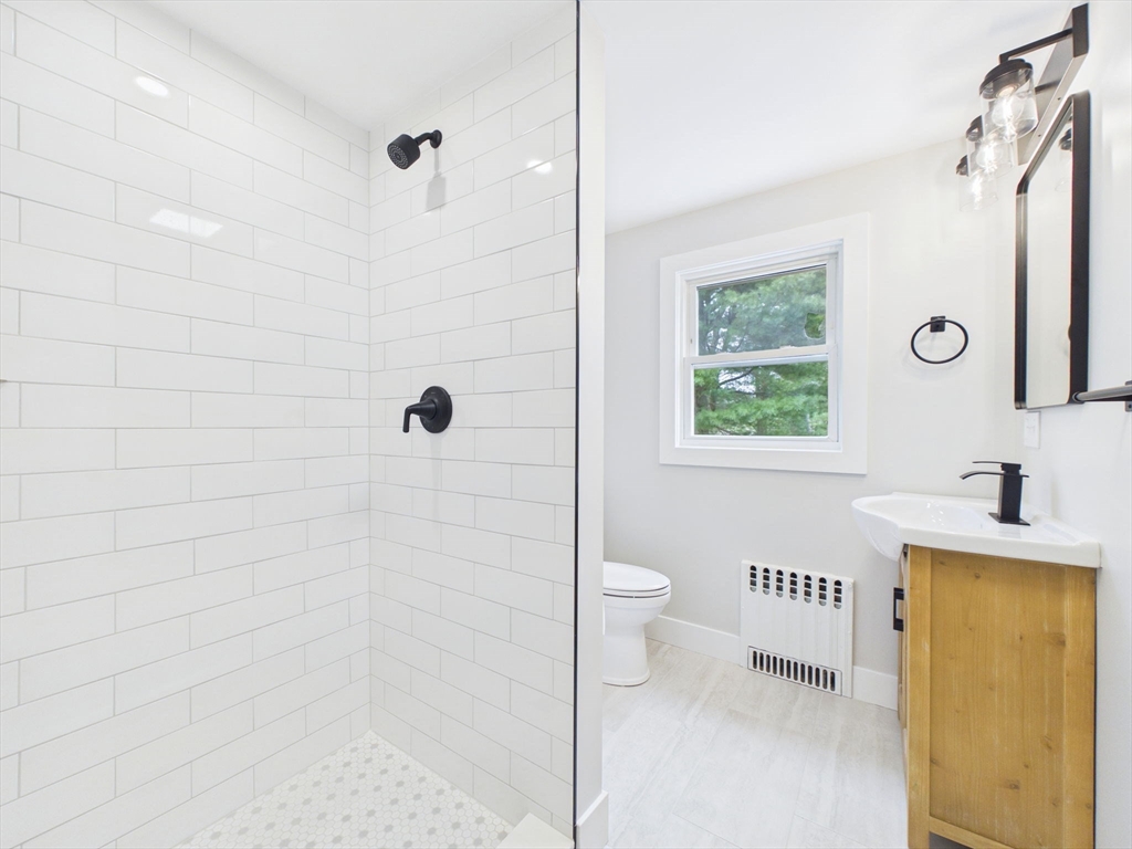 9 Burt Street Acushnet, MA 02743 - Photo 19 of 29 a bathroom with a granite countertop sink a toilet and shower