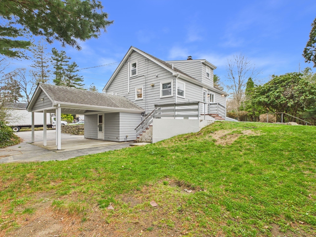 9 Burt Street Acushnet, MA 02743 - Photo 7 of 29 a front view of a house with a garden and yard