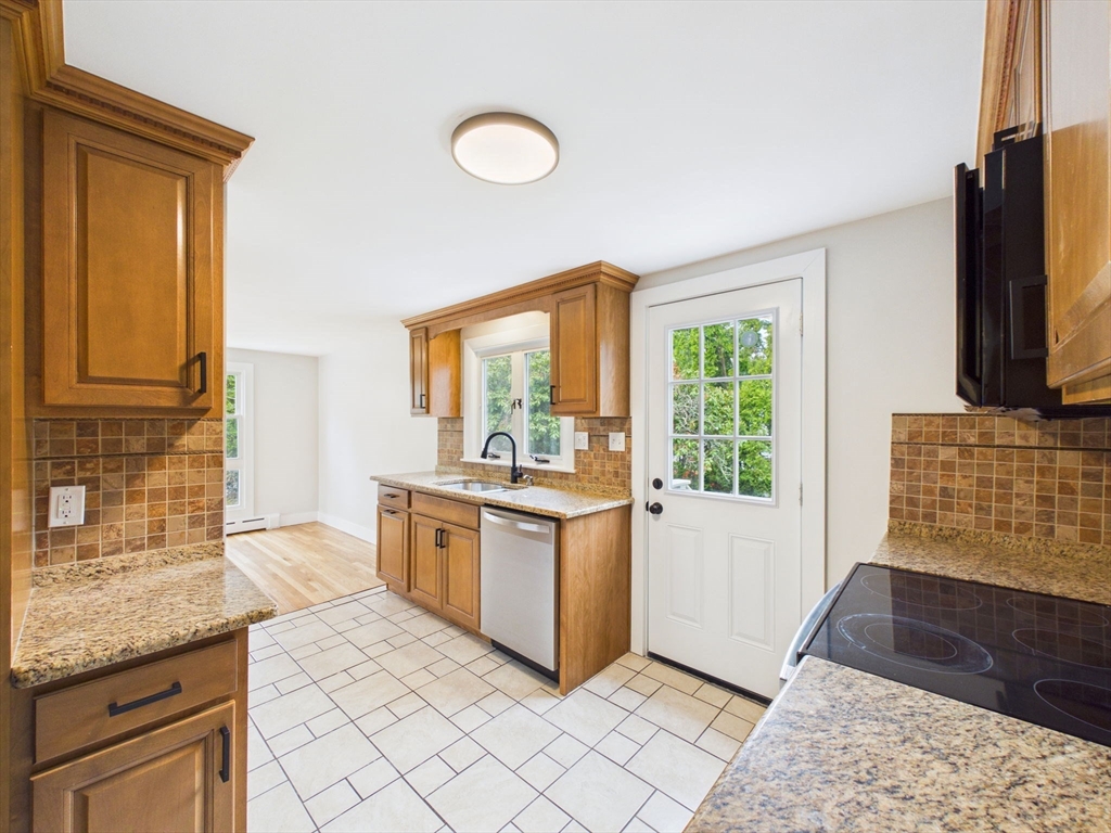 9 Burt Street Acushnet, MA 02743 - Photo 9 of 29 a kitchen with stainless steel appliances granite countertop a stove a sink and a microwave