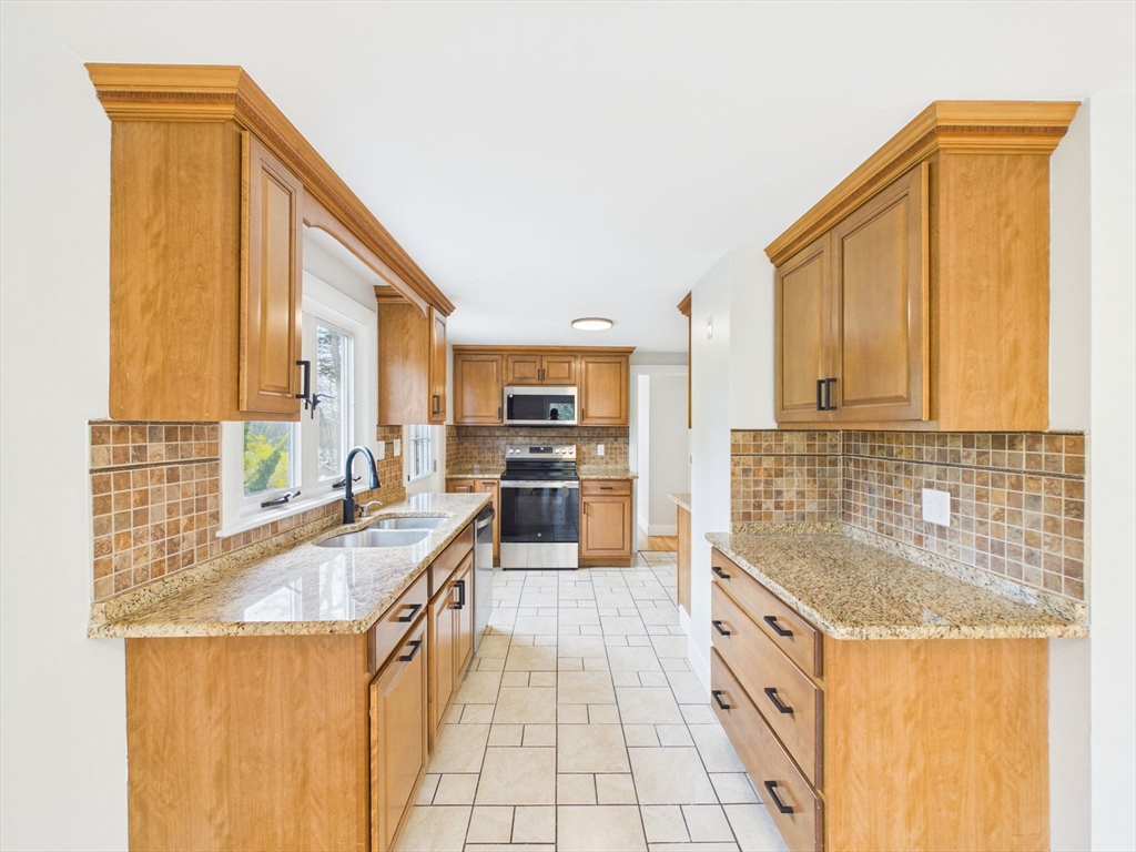 9 Burt Street Acushnet, MA 02743 - Photo 10 of 29 a kitchen with stainless steel appliances granite countertop a sink and a refrigerator