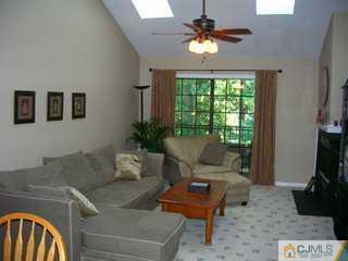 2810 Ridgefield Court Helmetta, NJ 08828 - Photo 4 of 8 a living room with furniture a chandelier and a window