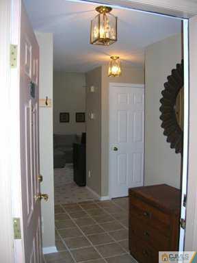 2810 Ridgefield Court Helmetta, NJ 08828 - Photo 7 of 8 a view of a hallway with wooden shelves