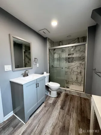 a bathroom with a sink toilet and shower