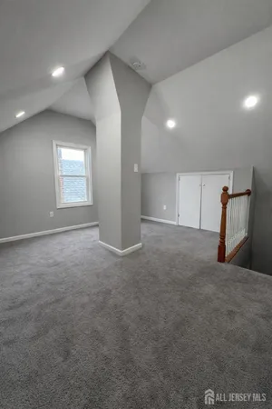 an empty room with a window and flowerpot