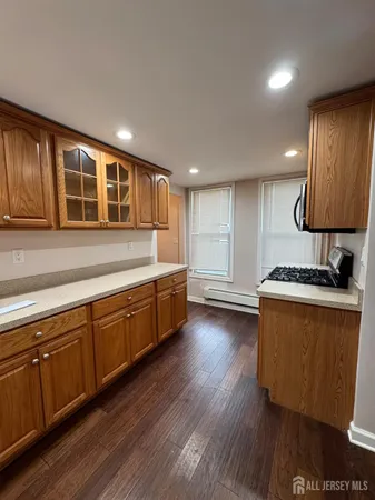 a kitchen with wooden floors and wooden cabinets