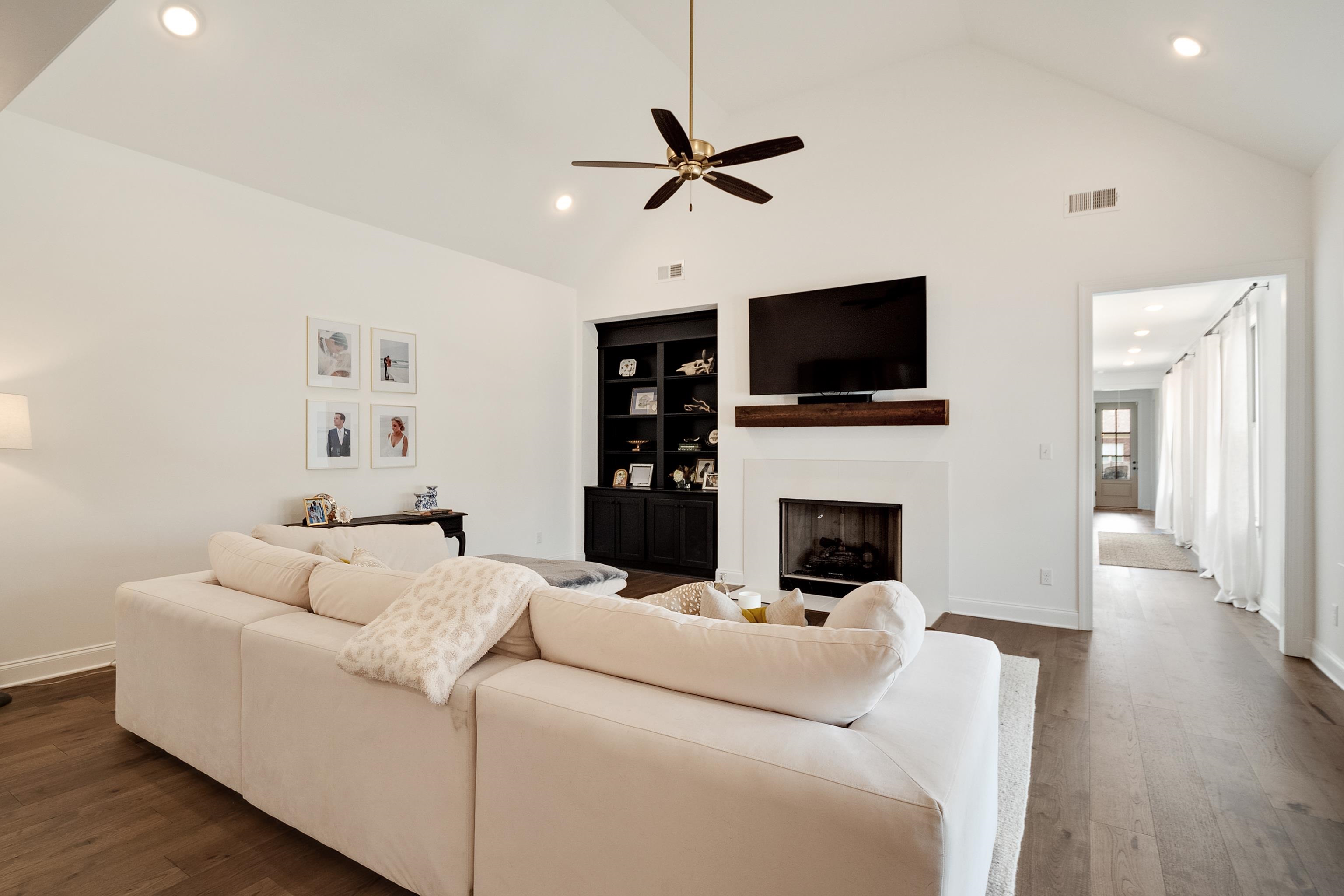 964 Collierville Arlington Road Collierville, TN 38017 - Photo 12 of 40 a living room with furniture a flat screen tv and a fireplace
