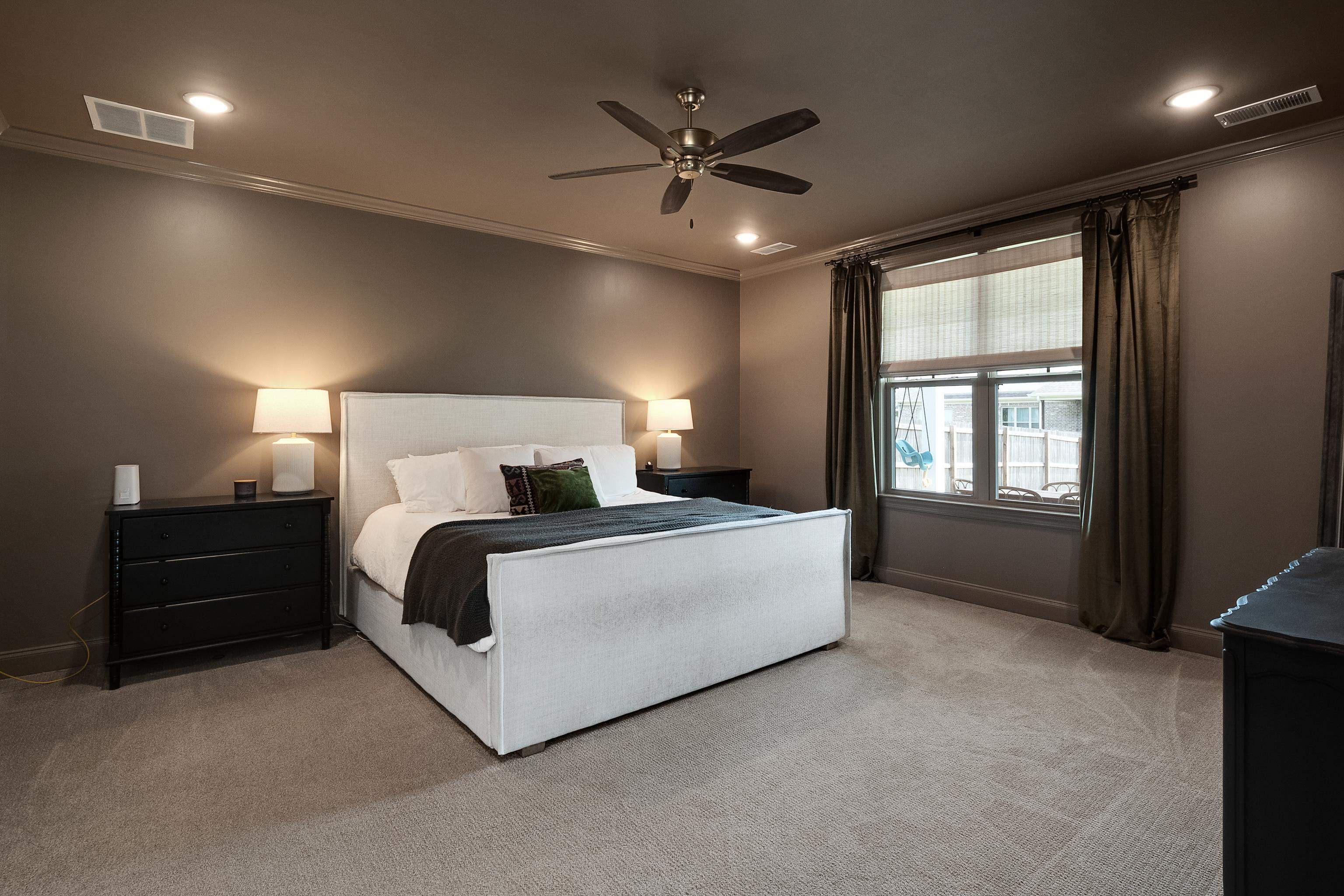 964 Collierville Arlington Road Collierville, TN 38017 - Photo 16 of 40 a bed room with a bed and a ceiling fan