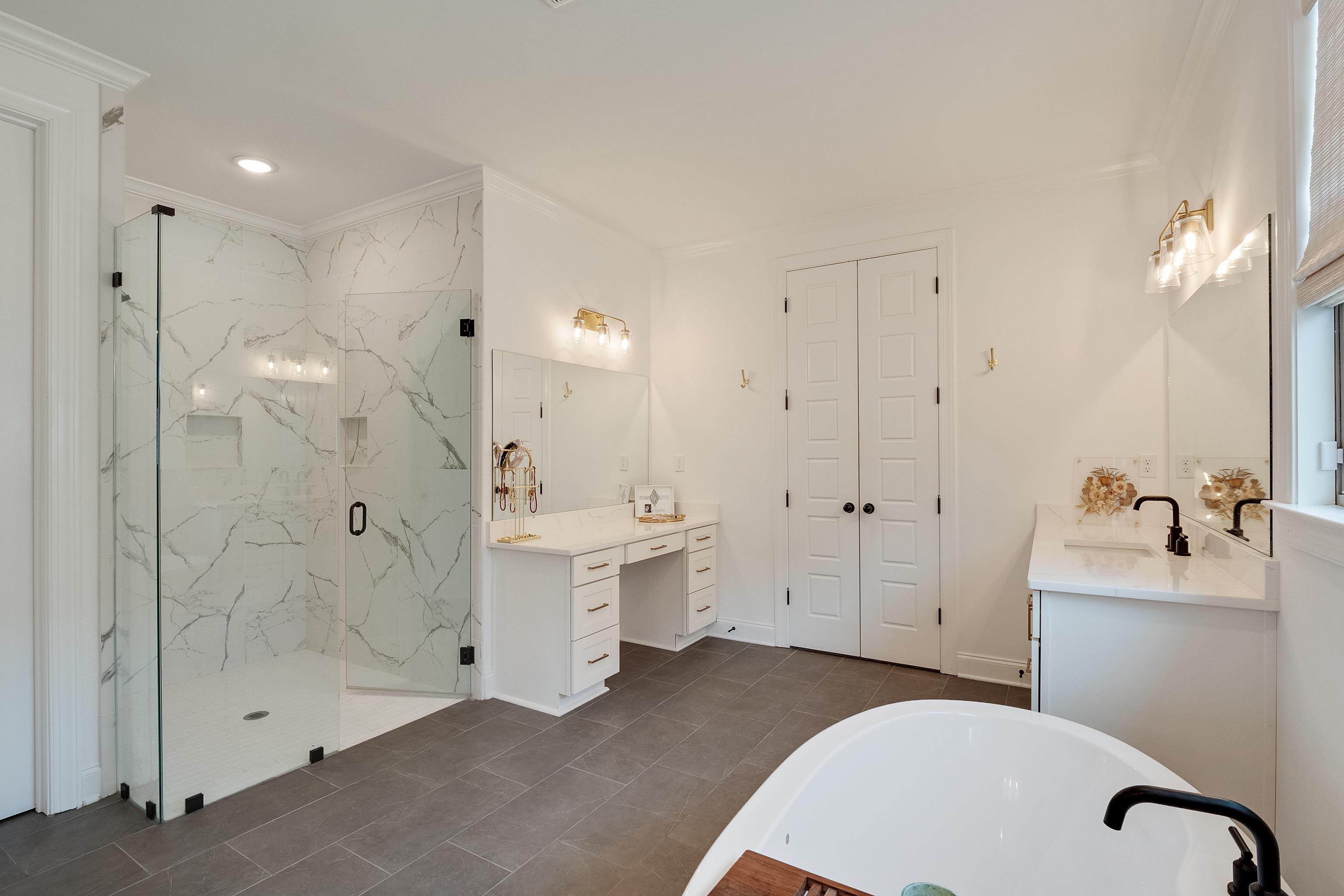 964 Collierville Arlington Road Collierville, TN 38017 - Photo 19 of 40 a spacious bathroom with a granite countertop sink mirror and shower