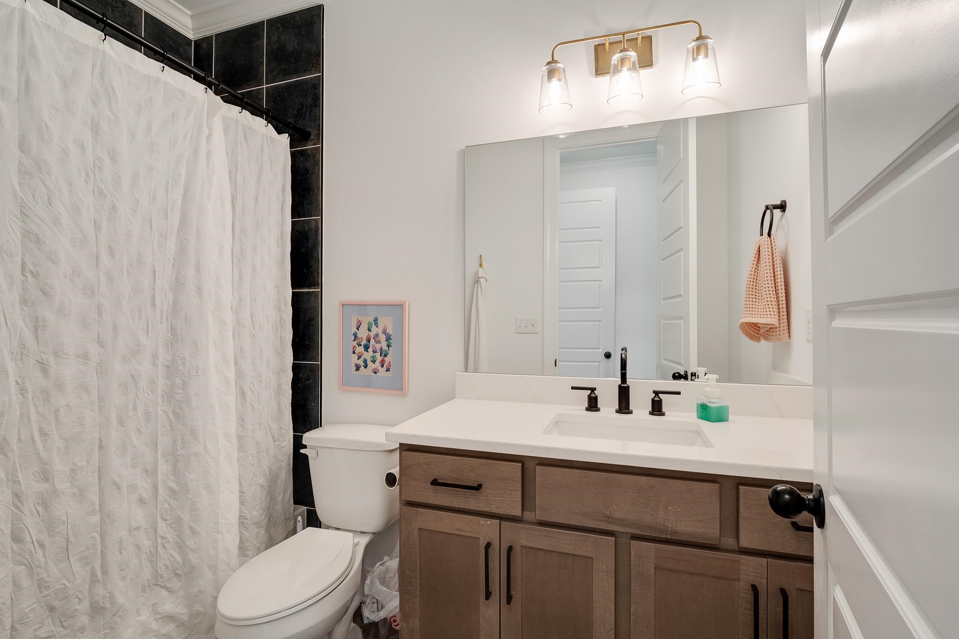 964 Collierville Arlington Road Collierville, TN 38017 - Photo 24 of 40 a bathroom with a sink toilet and mirror