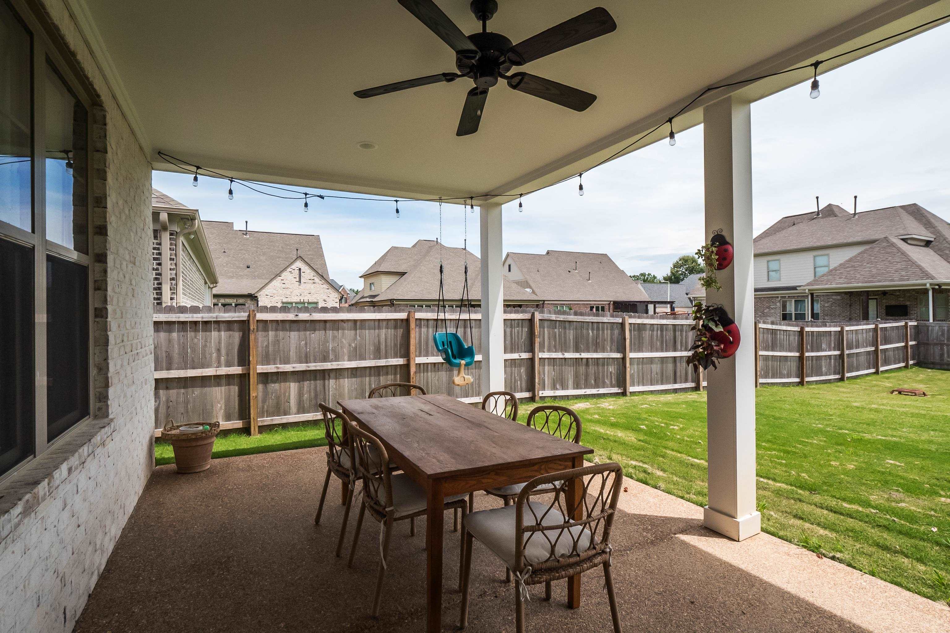 964 Collierville Arlington Road Collierville, TN 38017 - Photo 36 of 40 a view of a patio with a table chairs and a yard