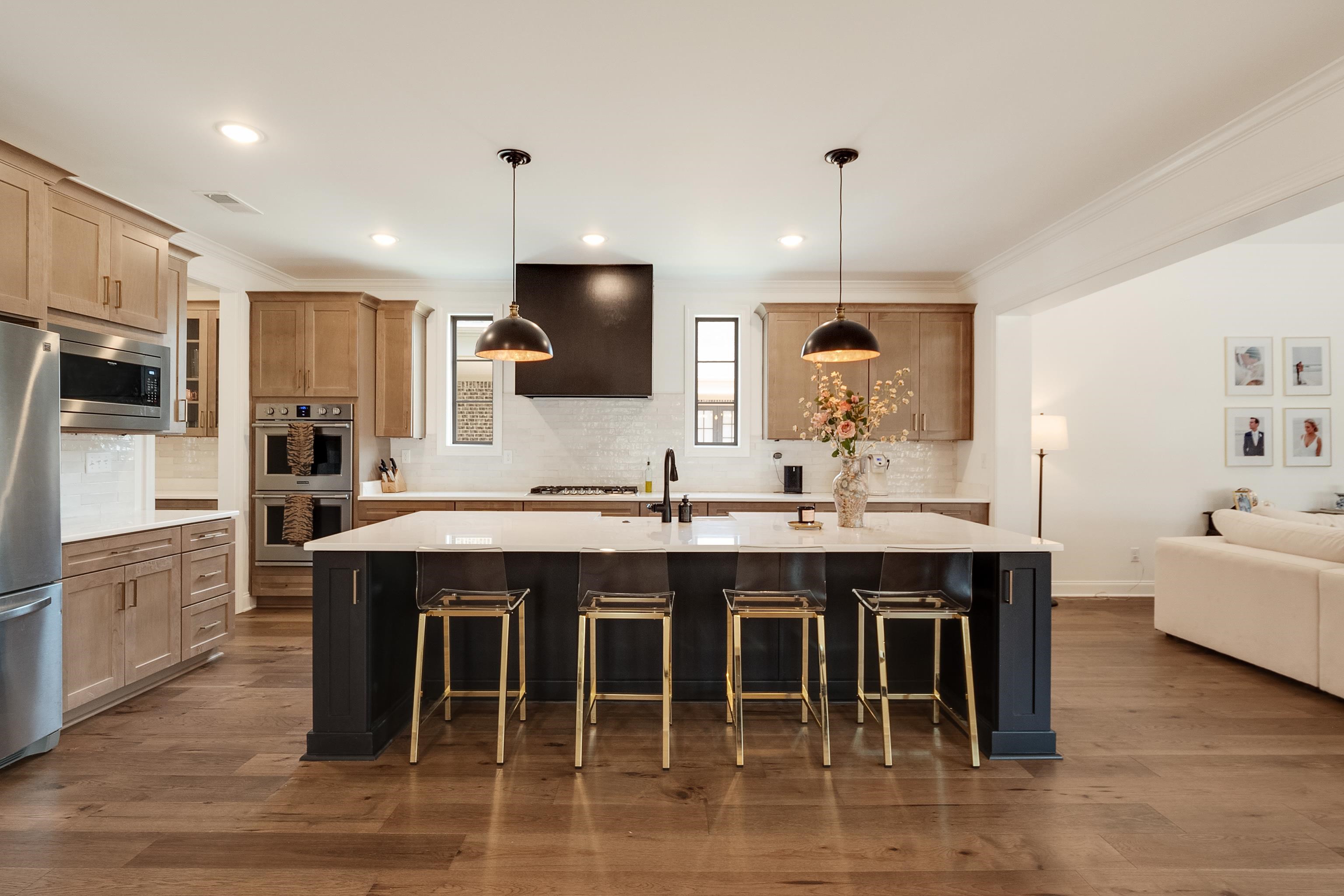 964 Collierville Arlington Road Collierville, TN 38017 - Photo 8 of 40 a kitchen with kitchen island granite countertop a sink counter and chairs