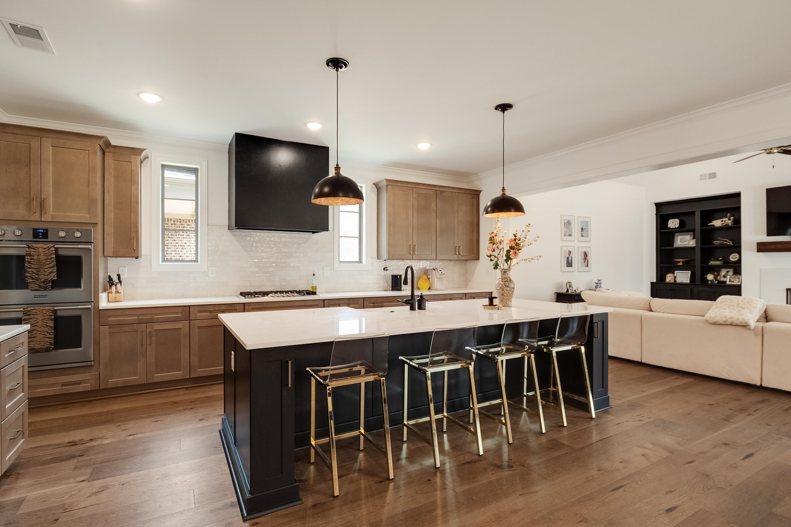 964 Collierville Arlington Road Collierville, TN 38017 - Photo 39 of 40 a kitchen with kitchen island granite countertop a table chairs sink and microwave