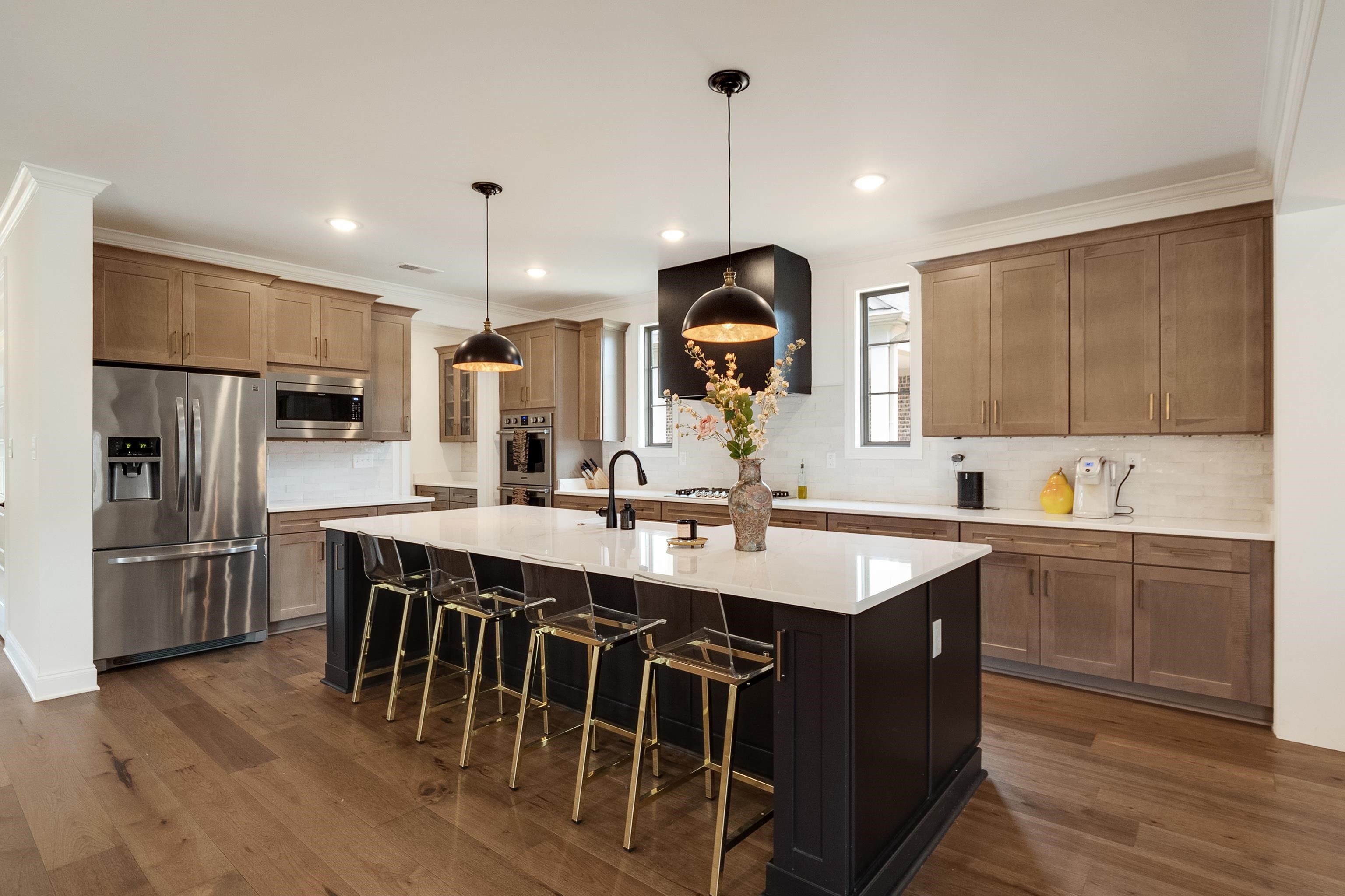 964 Collierville Arlington Road Collierville, TN 38017 - Photo 9 of 40 a kitchen with stainless steel appliances granite countertop a sink a stove a refrigerator and island
