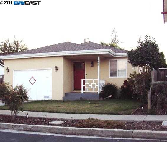 747 Tormey Avenue Rodeo, CA 94572 - Photo 1 of 1 a front view of a house with a yard and garage