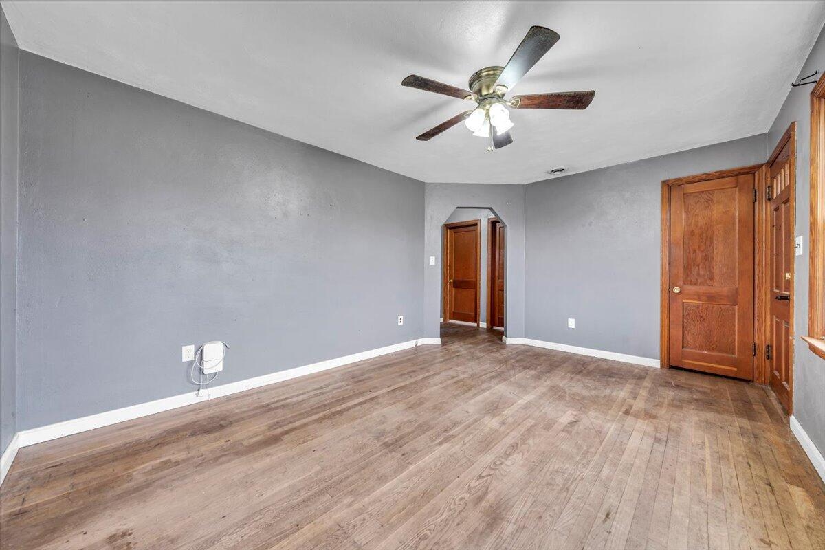 215 Post Road Roanoke, VA 24019 - Photo 4 of 42 a view of an empty room with wooden floor and a ceiling fan