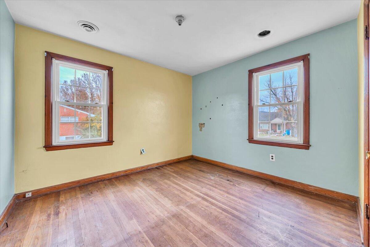 215 Post Road Roanoke, VA 24019 - Photo 8 of 42 a view of an empty room with wooden floor and a window
