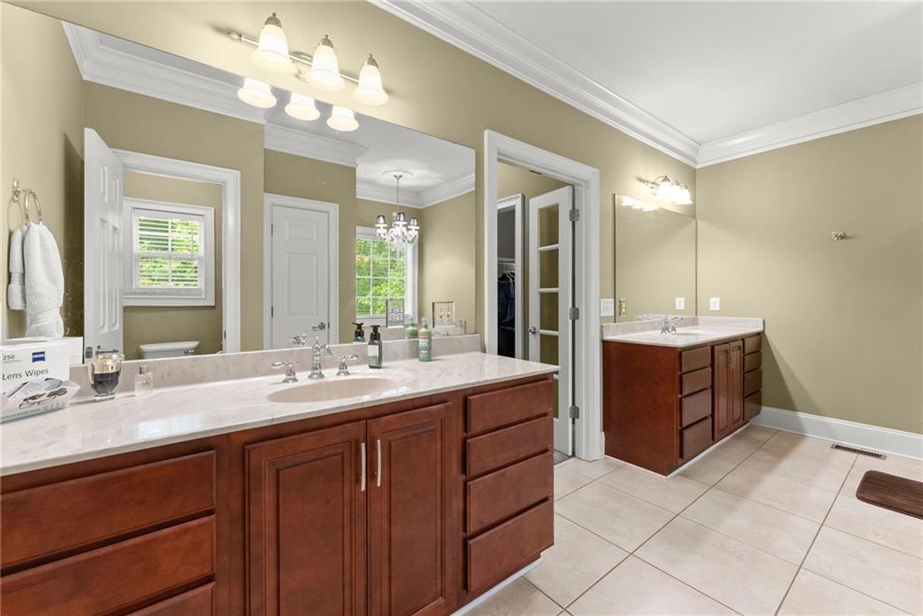 6643 Windvane Point Clermont, GA 30527 - Photo 31 of 88 a spacious bathroom with a double vanity sink mirror and a bathtub