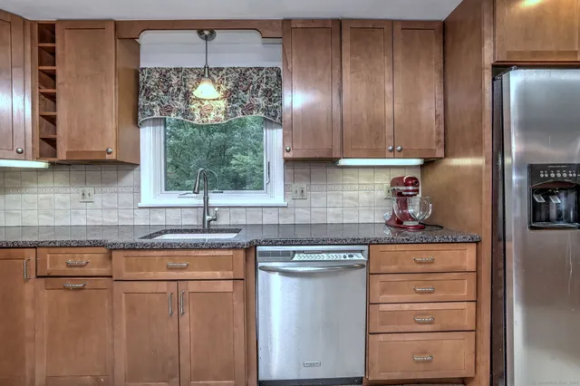 a kitchen with appliances cabinets and a sink