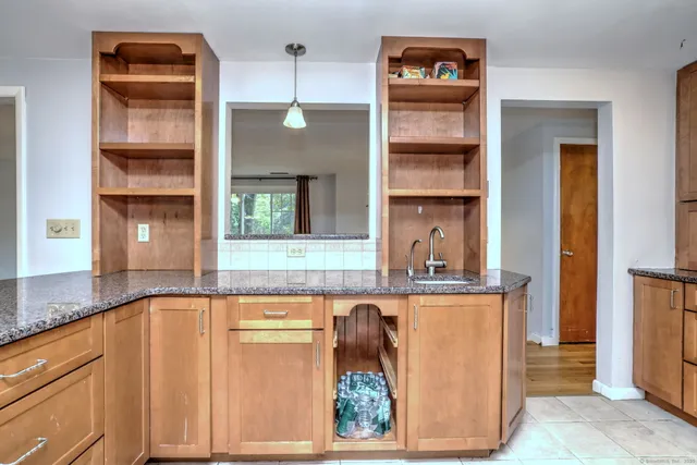 a kitchen with a refrigerator and cabinets