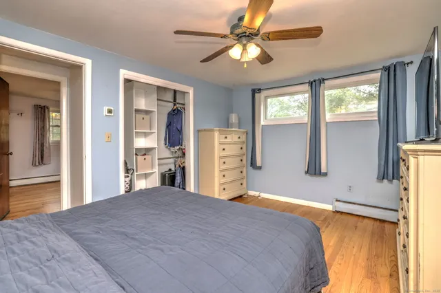 a bedroom with a large bed and a chandelier