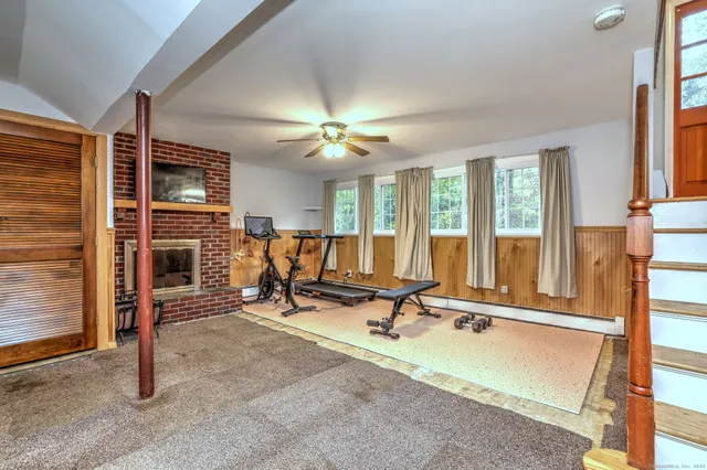 a view of a livingroom with workspace and a window
