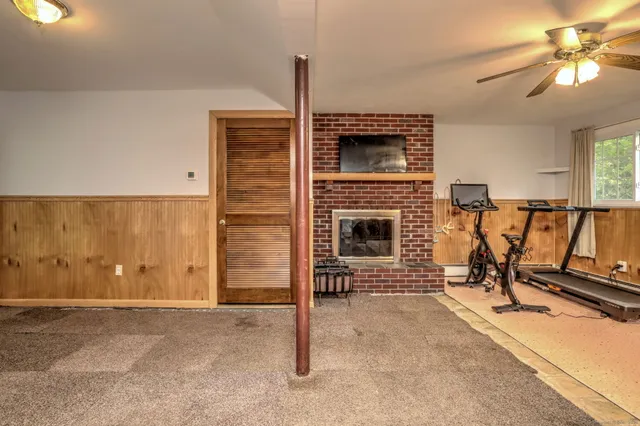 a view of a livingroom with furniture and a fireplace