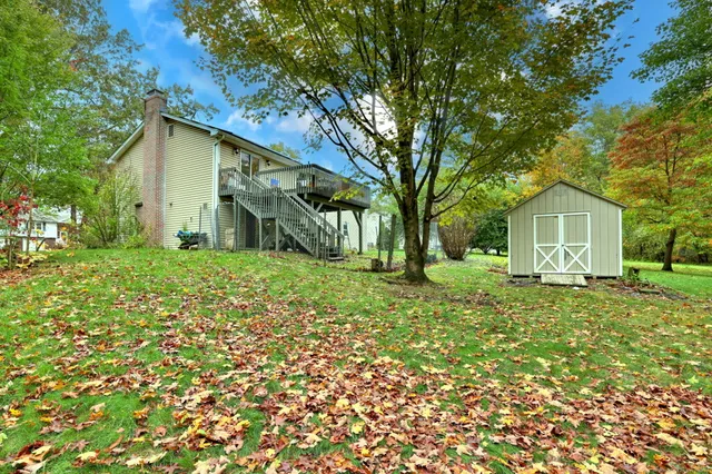 a house with green field in front of it