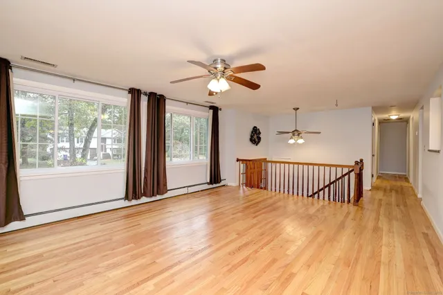 a view of livingroom with hardwood floor and ceiling fan